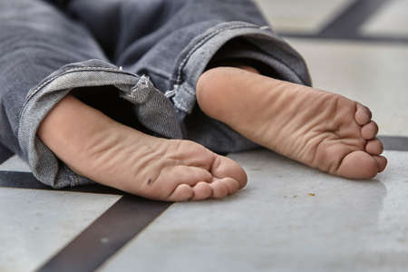 Kid's legs on marble floor.