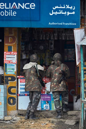 Road 44, Kashmir, India - February 18 2012 : soldiers of the Indian army buy SIM cards in a cellular store.のeditorial素材