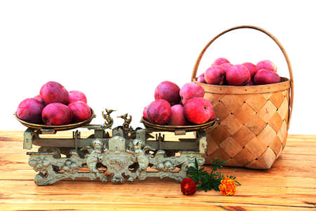Autumn apples in the basket and on the old mechanical scalesの写真素材