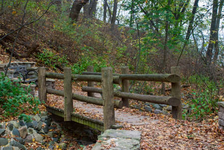 Autumn landscape with a wooden bridge, and dry creek, Lake Park, Milwaukee, Wisconsin, USAの写真素材