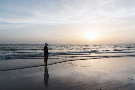 Slender young woman enjoying the sunset on the shores of the Gulf of Mexico, Florida, USAの写真素材
