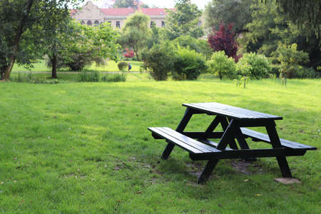 Bench with a table in the old palace garden on a mown lawn.の写真素材