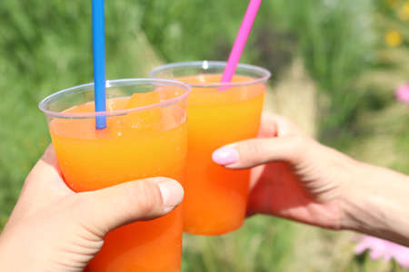 Orange crushed ice in a cup with a straw. Served typically at every stall in the summer.