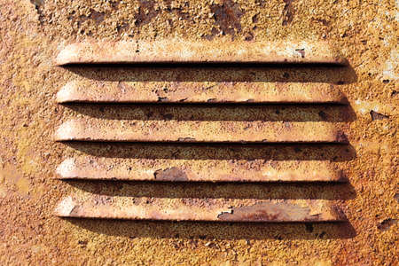 Texture of an old sheet metal plate and ventilation holes, which was painted white.の写真素材