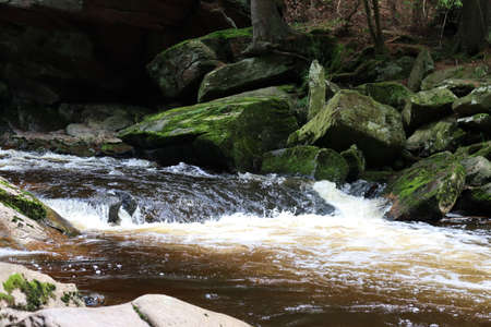 A wild river flowing through a mountain valley.の写真素材