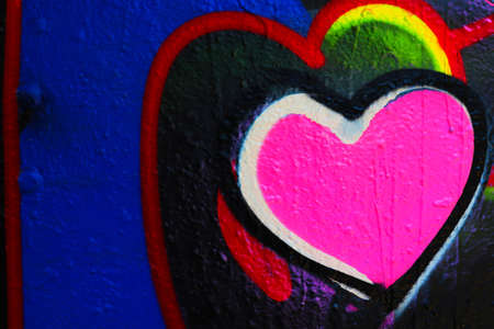Sprayed wall texture with pink hearth. Part of graffiti.の写真素材