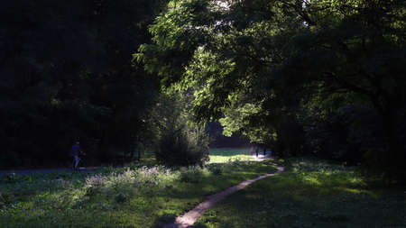 Route through a romantic valley with people and cyclistsの写真素材