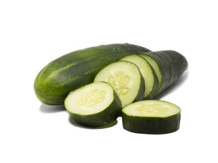 Cucumbers and slices on a white background with one whole and half cucumber. Completely clean. Ready for further processing.の写真素材