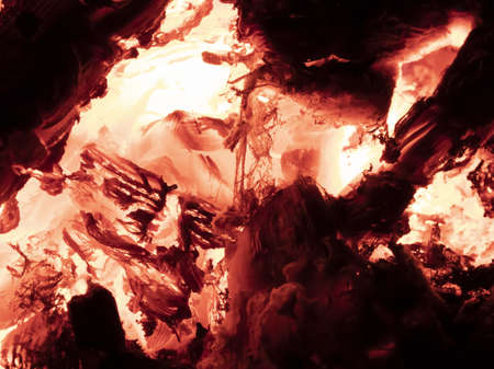 Macro shot of red hot coals in a fireplace.