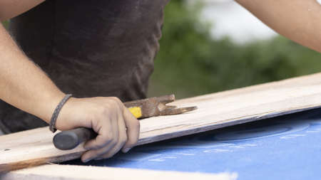 The worker is preparing a batten for nailing to the roof.の写真素材
