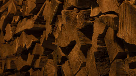 Texture of firewood photographed at night in the yellow light.の写真素材