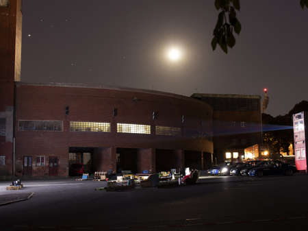 People are watching a movie in a car cinema in the moonlight.のeditorial素材