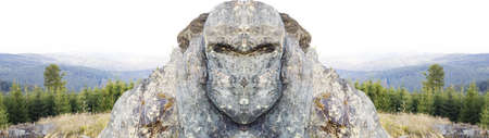 Head and shoulders of a golem on top of a mountain.の写真素材