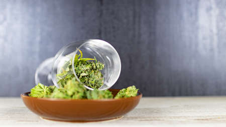 Fresh cannabis flowers in a wine glass and bowl after harvestの写真素材