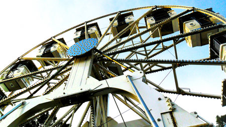 Large Ferris wheel with a central hub and visible structural beams, shot from below