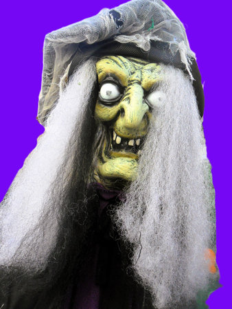 Halloween ghost with long gray hair and green eyes on purple backgroundの写真素材