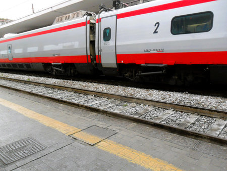 The Frecciargento train, characterized by its distinctive white, red, and silver livery, is depicted...