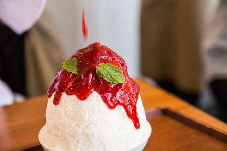 smoothie ice cream on top with strawberry syrupの写真素材