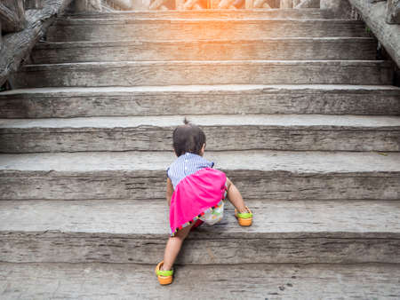 little girl  try to go to the top by herselfの写真素材