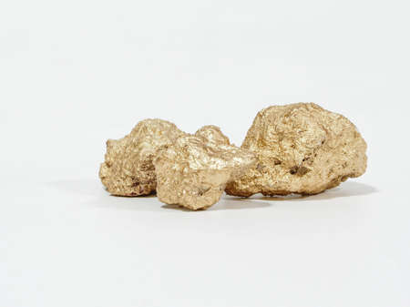 Gold gemstones are mined from gold mines on white backgroundの写真素材