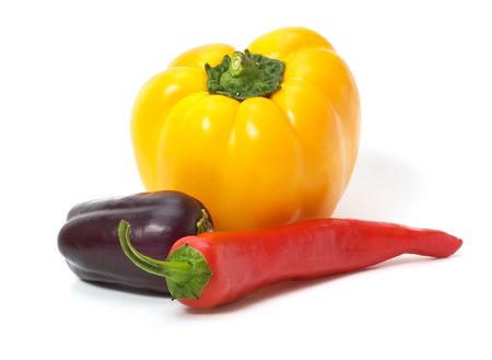 Yellow  and red  peppers with eggplant isolated on white with shadowsの写真素材