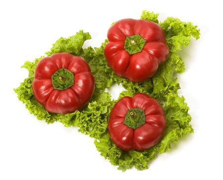 Red bellpeppers on leaves of salad isolatedの写真素材