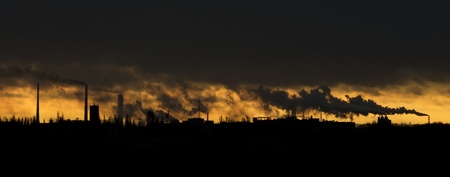 Landscape with a lot of chimneys polluting airの写真素材