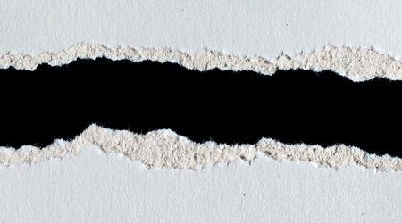 Pieces of torn paper isolated on blackの写真素材