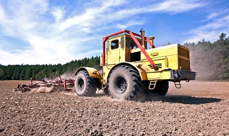 Tractor at work on the fieldの写真素材