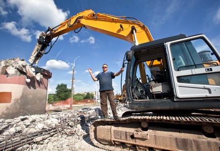Ð¡onstructor with hydraulic hammer destroys reinforced concrete structuresの写真素材