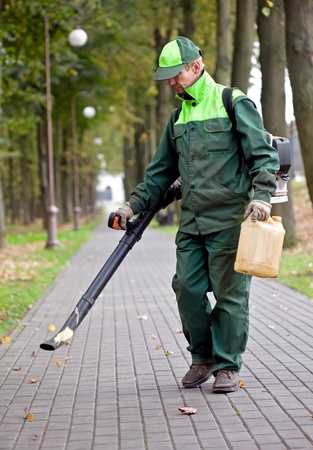 Landscaper cleaning the track using Leaf Blowerの写真素材