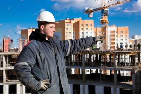 A foreman gives instructions to construction workers at a building site の写真素材