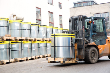 Forklift stacker transporting cargo with palletの写真素材