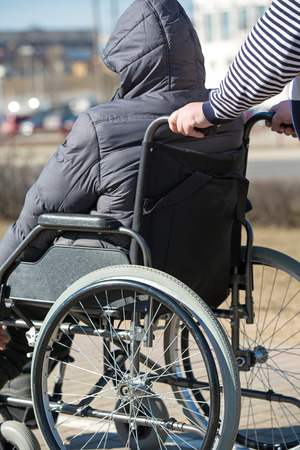 People with limited mobility take a walk with a rollator wheelchair outdoorsの写真素材