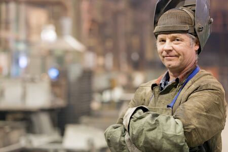 Portrait factory senior welder worker on manufacture workshop backgroundの写真素材