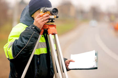 Professional engineer surveyor making measure with tacheometer theodolite before startup construction worksの写真素材