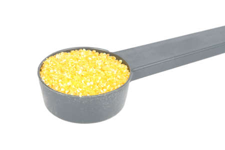 corn grits poured into a spoonの写真素材