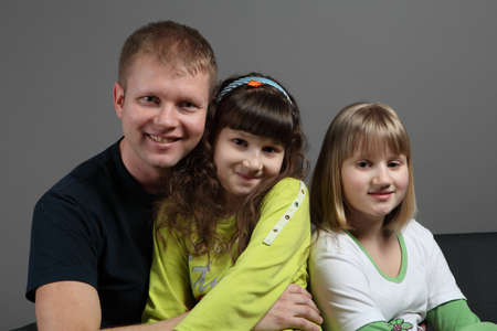 happy dad with two daughters teensの写真素材