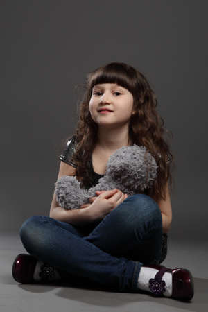 portrait of baby girl european exterior gray backgroundの写真素材
