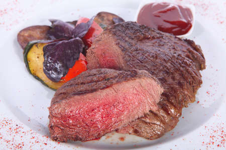 roasted beef steak on a white plateの写真素材