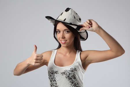girl cowboy showing okay sign isolated on a white backgroundの写真素材