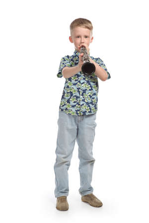 boy playing a clarinet isolated on a white backgroundの写真素材