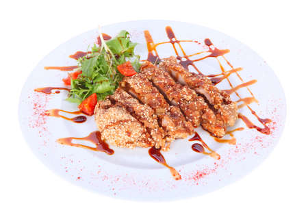 grilled meat, breaded with sesame seeds on a plate isolated on white backgroundの写真素材