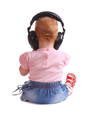 the child listens to music isolated on white backgroundの写真素材