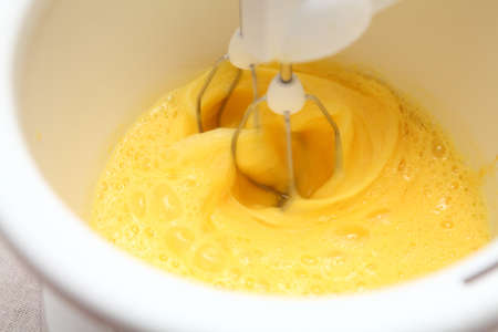 whisking eggs in a blenderの写真素材