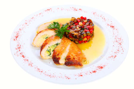 grilled chicken on a plate garnished with fresh vegetables isolated on white backgroundの写真素材