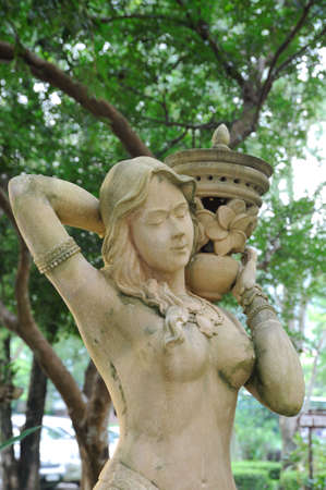 Women shoulder the earthenware flower style statue