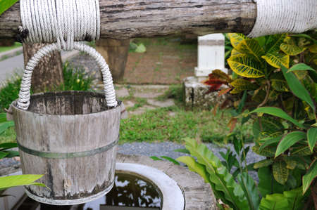 the wooden water bucket on the poolの写真素材