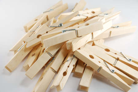 The wooden clothespin pile up on the white background
