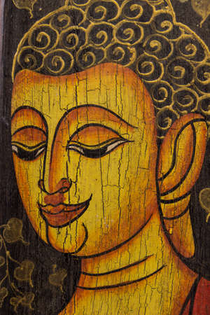 Buddha image on wooden wallの写真素材
